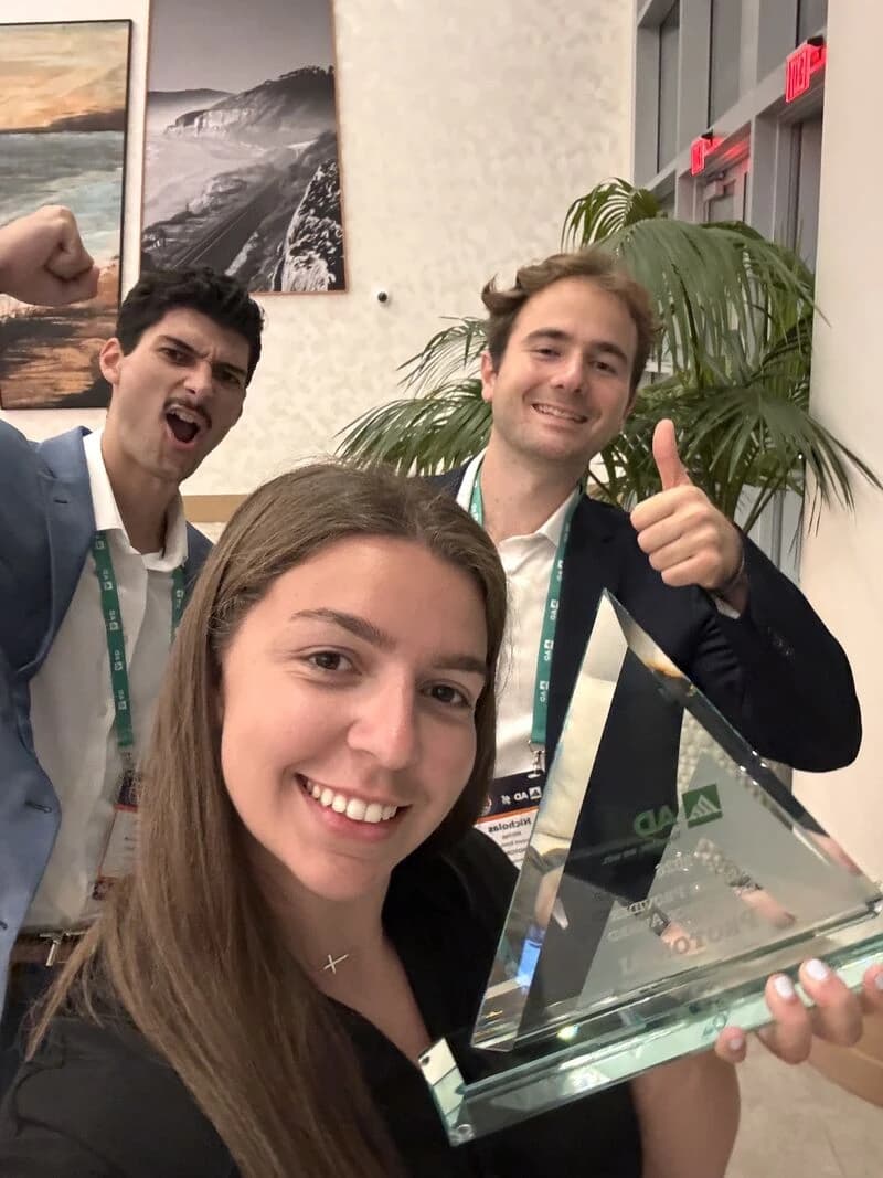 Three members of the Proton team celebrating with the glass AD Service Provider Excellence award